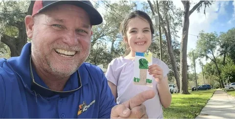 David Saitta of 904Tree.com with his daughter holding a handmade tree craft in Jacksonville FL