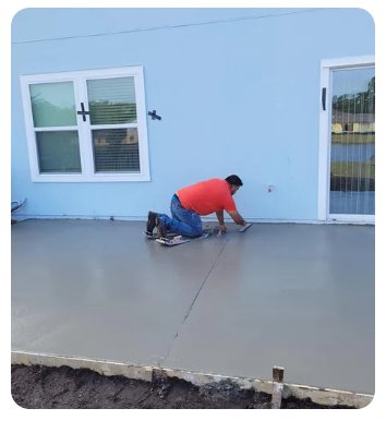 904Tree crew member finishing a freshly poured concrete patio slab in Northeast Florida