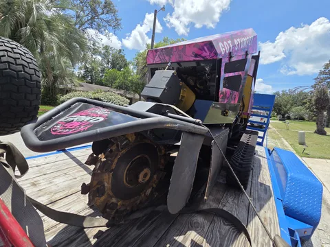 904Tree stump grinder side view showing grinding wheel, tracks, and Got Stumps? decal